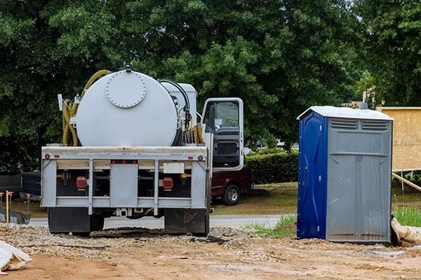 RapidClean service truck servicing a portable toilet unit in the field