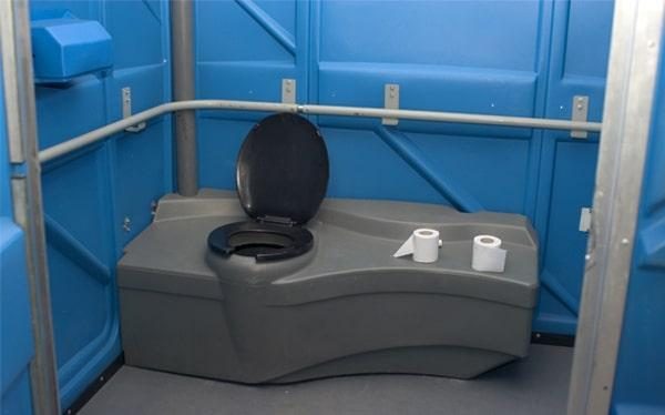 Interior of an ADA accessible portable restroom showing the grab bar