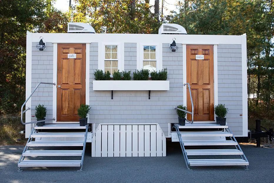 Upscale wedding restroom trailer with wood steps and planters