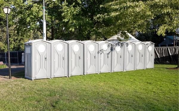Row of upscale portable restrooms set up for a formal outdoor event